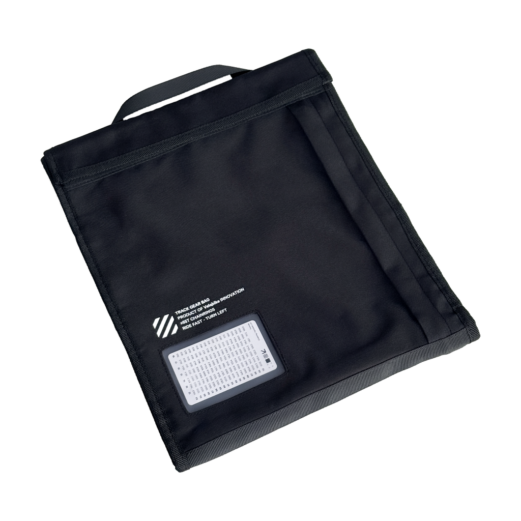 A black fabric chainring bag with a top handle, featuring a clear plastic window on the lower left containing a white gear chart card, set against a plain white background.